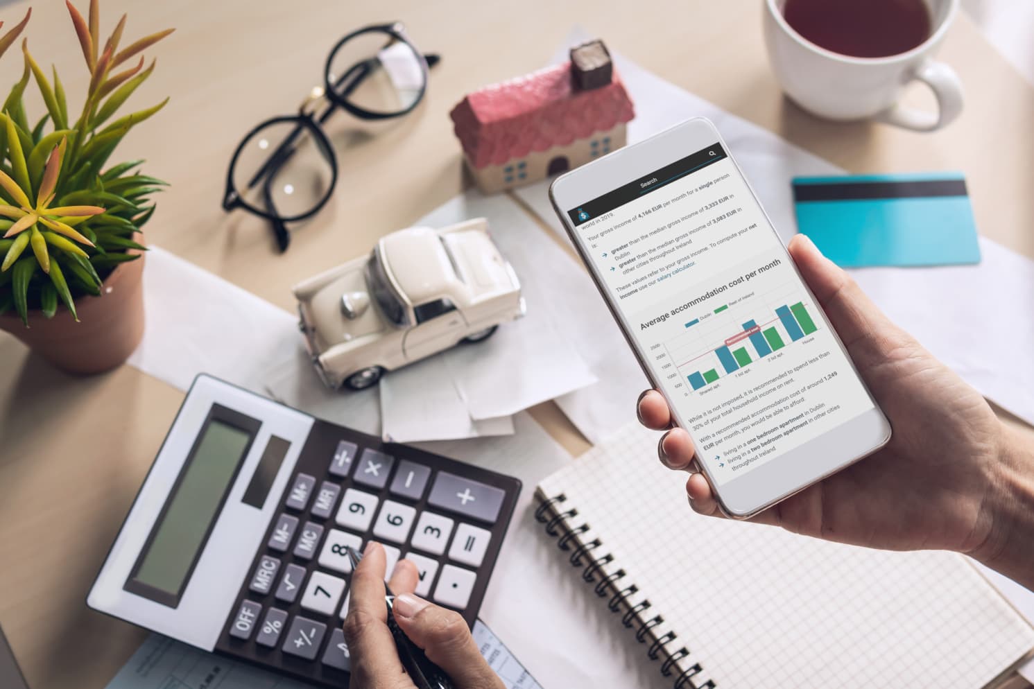 Person diligently checking the SalaryAfterTax Cost of Living Calculator page on their mobile phone
