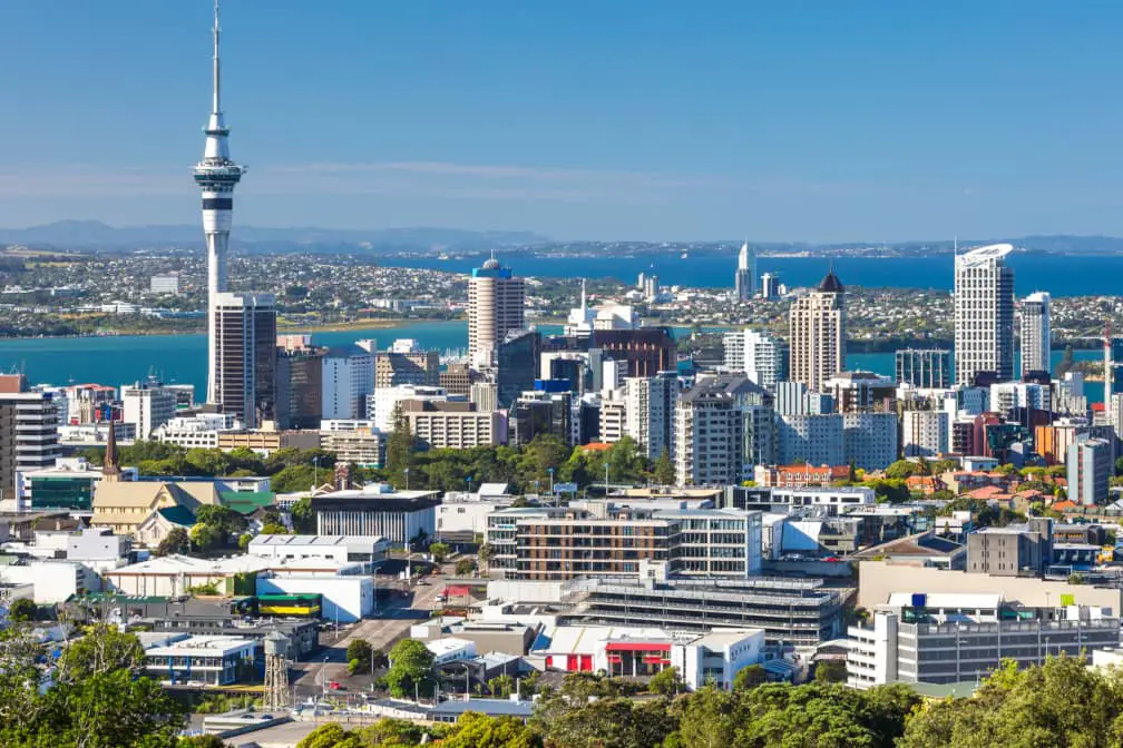 View of downtown Auckland and the imposing Sky Tower, with the North Shore suburban area visible in the distance